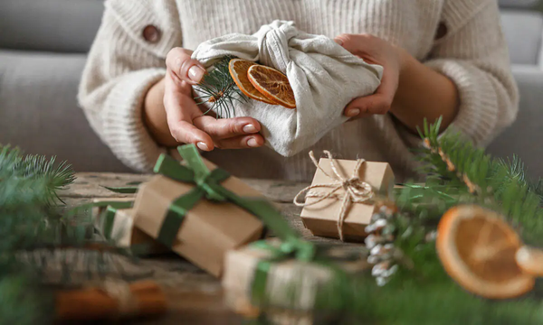 Woman opening gifts wrapped sustainably